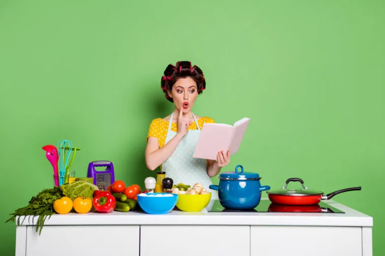 photo astonished shocked girl gourmet chef read recipe cook book want prepare tasty veggie organic supper wear yellow style stylish trendy t-shirt hair rollers isolated green color background – mobile marketing reads