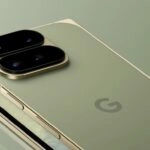 image1786465456 – mobile marketing reads Close-up of a gold smartphone lying on its back, showing a dual-camera bump on the left side.